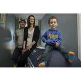 Family with child sitting on Oxynova 7 portable hyperbaric chamber.
