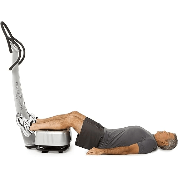 man lying down and exercising on Power Plate my3 Full Body Vibration Platform