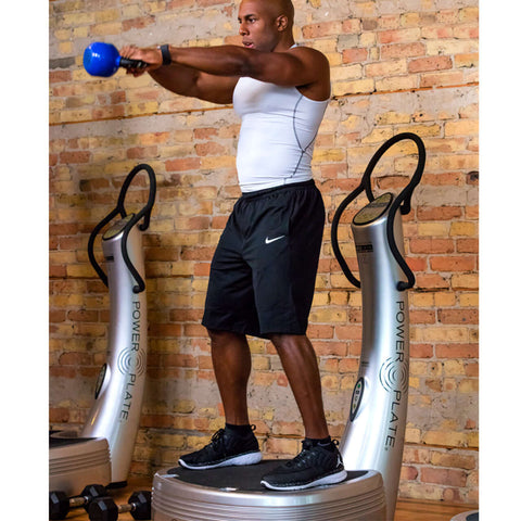 man doing kettler bell exeercise on Power Plate Pro5 fitness equipment with vibration technology