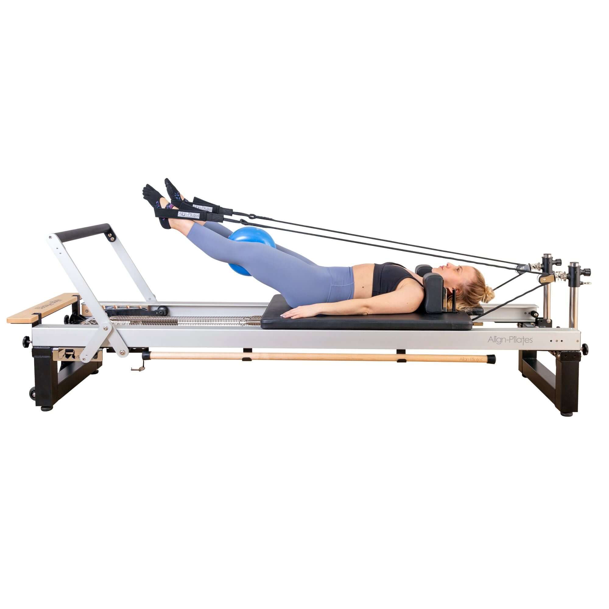 Instructor demonstrating a Pilates move on the Align Pilates A8 Pro Reformer, highlighting its ergonomic design.
