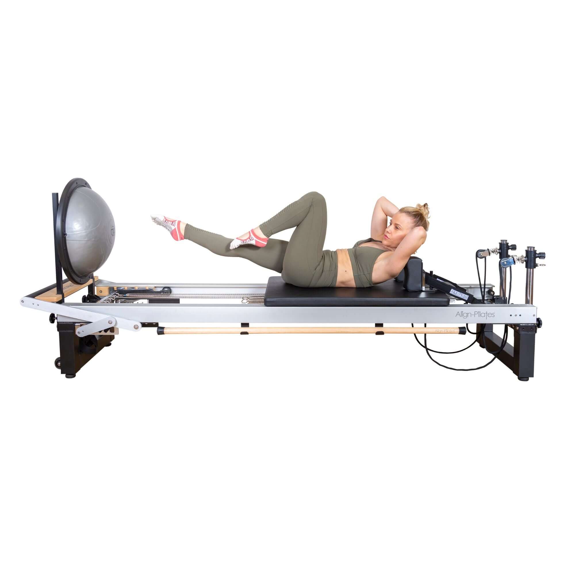 Athlete performing advanced Pilates moves on the Align Pilates A8 Pro Reformer, demonstrating its durability.