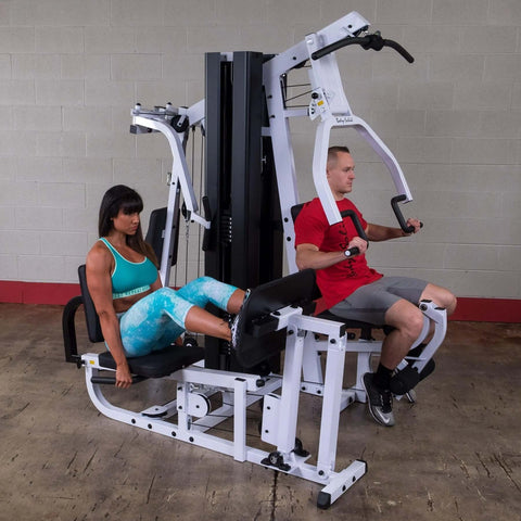 man and women working out on body solid exm3000lps