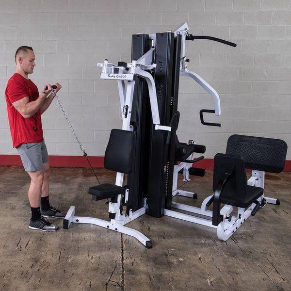 man doing bicep curl on body solid exm3000lps home gym