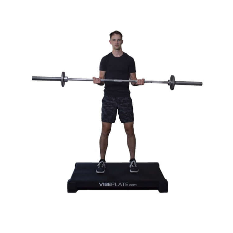 Male model with barbell on VibePlate 3048 Whole Body Vibration Machines 