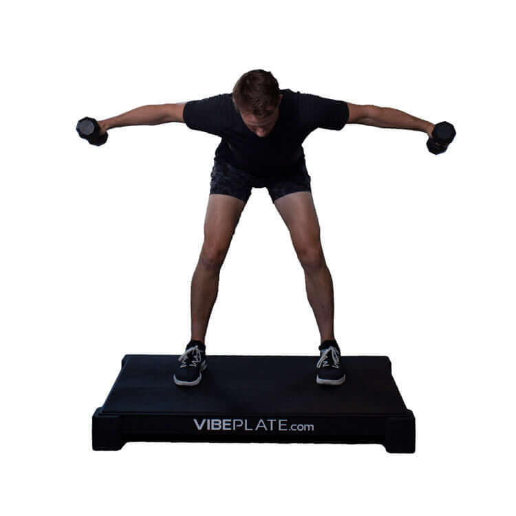 Male model with dumbell  on VibePlate 3048 Whole Body Vibration Machines 