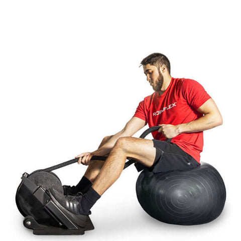 man sitting on a balancing table and working out on RopeFlex RX2000 Mini Rope Trainer