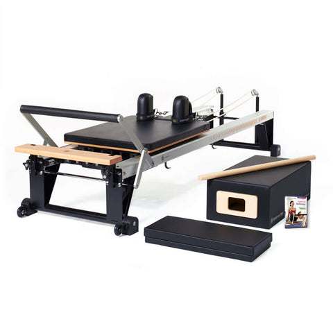 An image showing the sleek and professional MERRITHEW PILATES V2 MAX REFORMER in Gunmetal Gray, characterized by its black color
