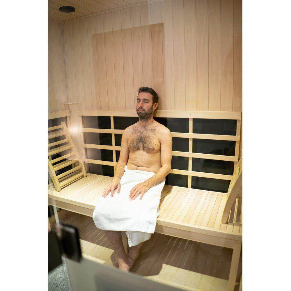 Person relaxing in a Halo IR sauna with visible sweat for detox